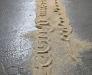 Artwork: Passage (detail) 2019 by artist Emma Lloyd, stencilled sand